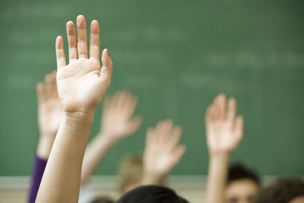 o-classroom-hands-facebook Hands raised in classroom