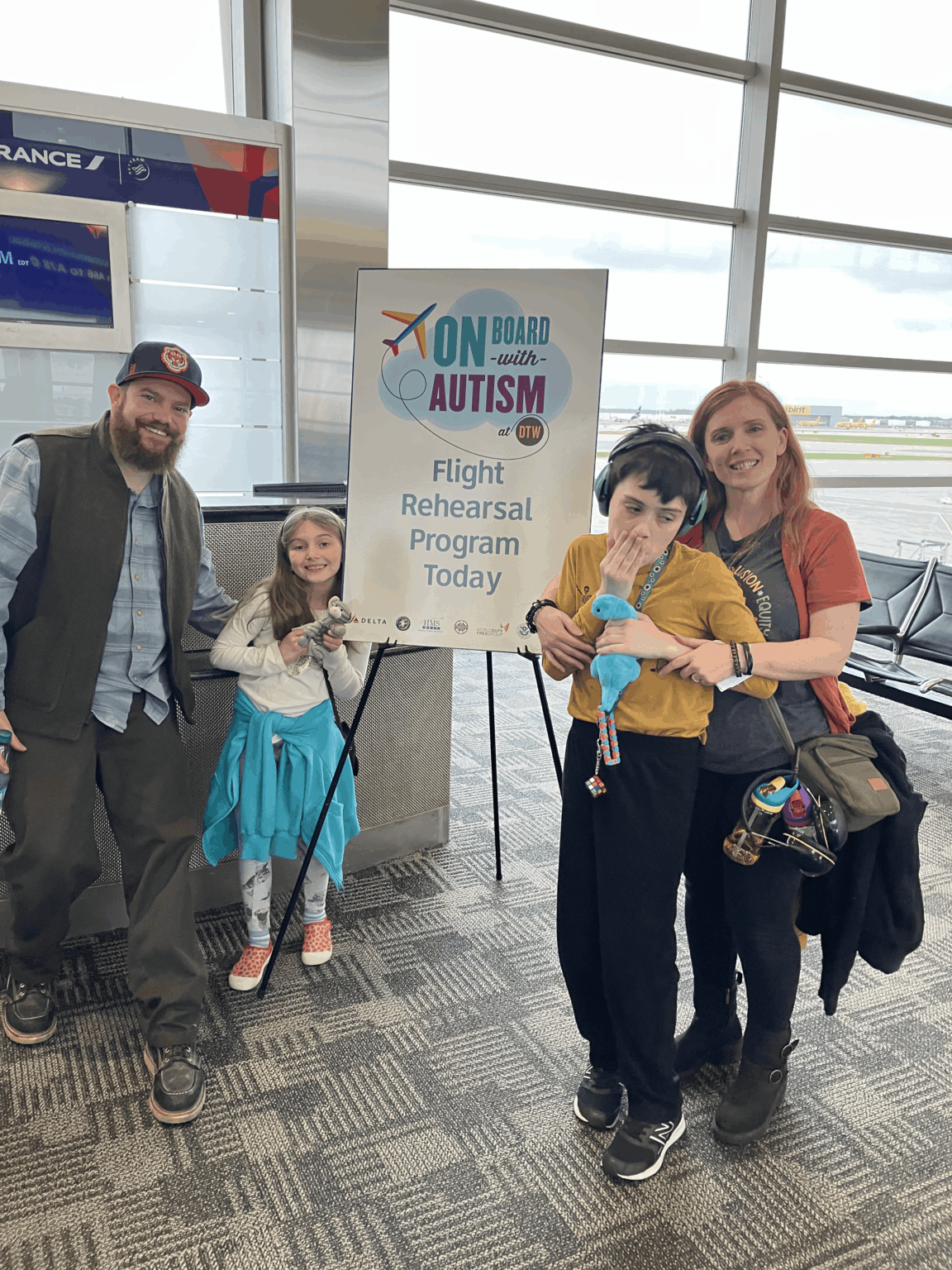 family at boarding gate 5